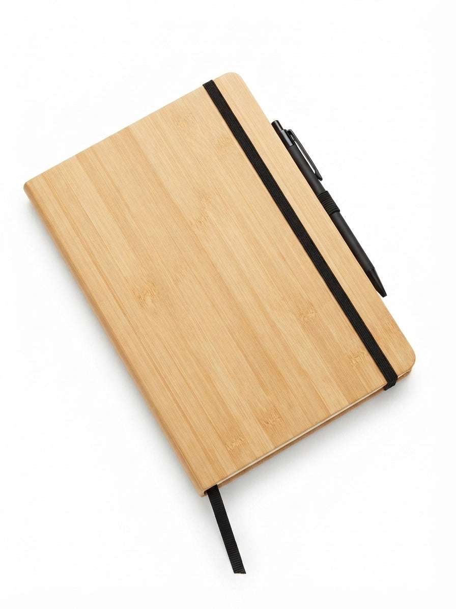 Bamboo and cork notebook and bamboo desk items arranged for a sustainability audit
